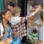 Hadley placing canned goods on a shelving unit.