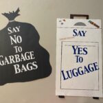 Signs with "Say no to garbage bags" and "Say yes to luggage"