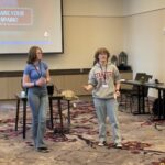 Hadley standing at the front of a room giving a presentation.