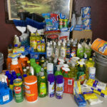 A close shot of a table full of donated cleaning supplies for the Hadley's Bags of Hope event.