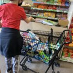 Hadley with shopping cart full of essentials.