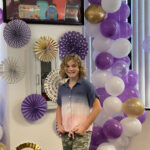 Hadley standing in front of decorations at the Hadley's Bags of Hope event.