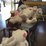 Shopping carts filled with large stuffed animals.