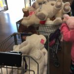 Shopping carts filled with large stuffed animals.