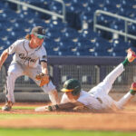 Baseball players in game.