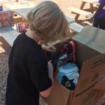 Hadley looking into a box of donations.